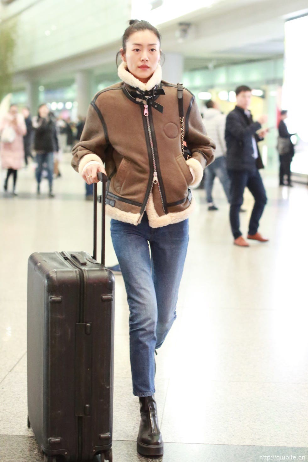 a woman with a suitcase 冬日暖阳下的时髦选择:毛领夹克